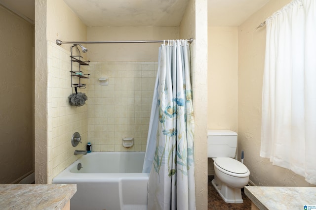 full bathroom featuring vanity, shower / bath combination with curtain, and toilet