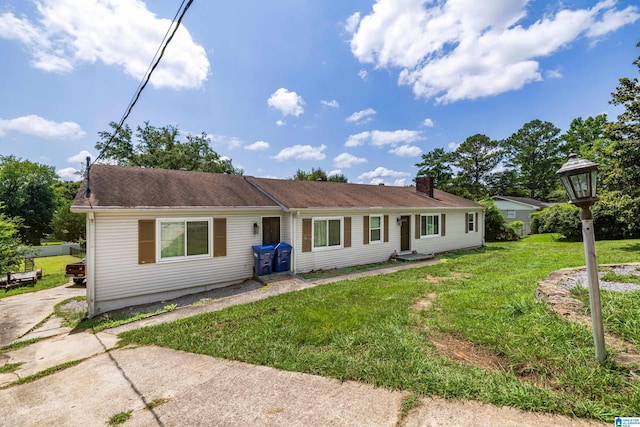 single story home featuring a front lawn