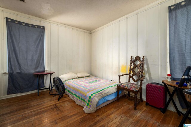 bedroom with dark hardwood / wood-style floors