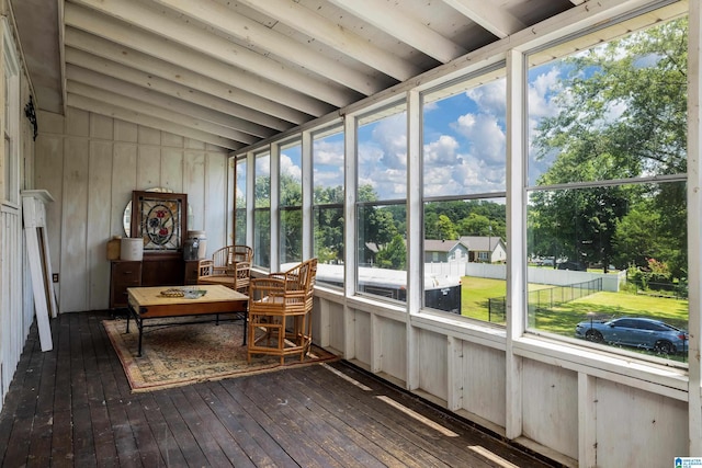 sunroom featuring vaulted ceiling