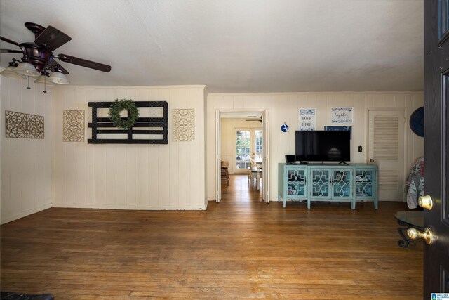 unfurnished living room featuring ceiling fan and wood-type flooring