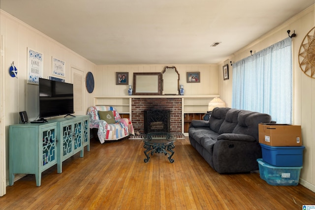 living room featuring wood-type flooring and a fireplace