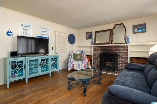 living room featuring hardwood / wood-style flooring and a brick fireplace