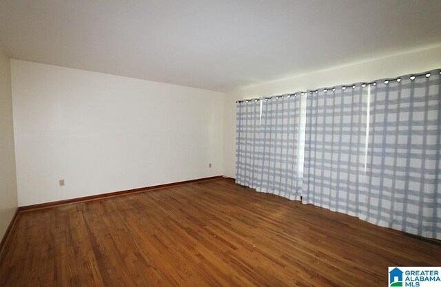 spare room with dark hardwood / wood-style flooring