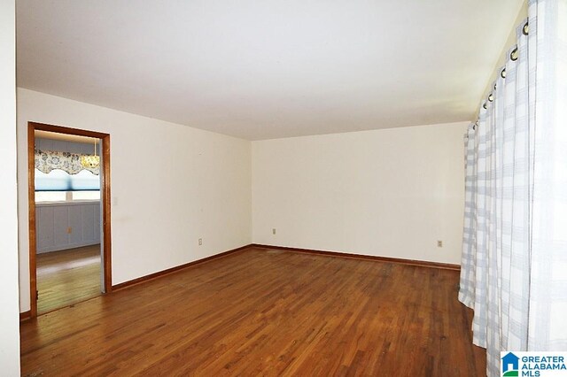 empty room with dark hardwood / wood-style floors