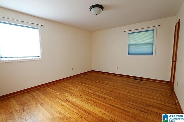 empty room with hardwood / wood-style floors