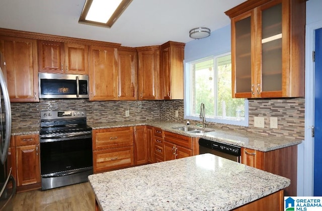 kitchen featuring tasteful backsplash, stainless steel appliances, sink, light stone countertops, and dark hardwood / wood-style floors