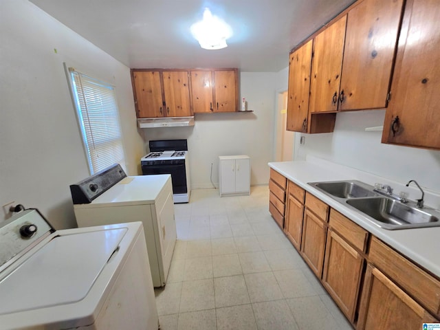 washroom with sink, washer and dryer, and light tile patterned floors