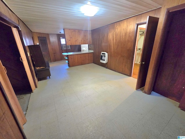 interior space with wood walls and light tile patterned floors