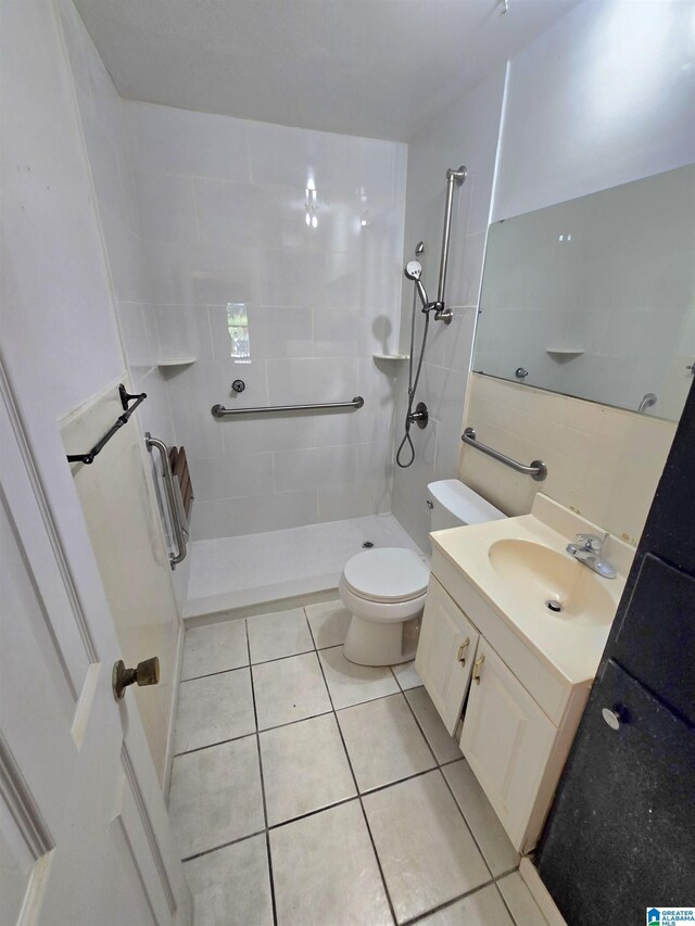 bathroom featuring vanity, toilet, and tile patterned flooring