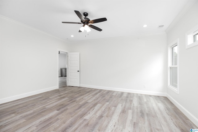 spare room featuring ceiling fan, light wood-type flooring, and crown molding