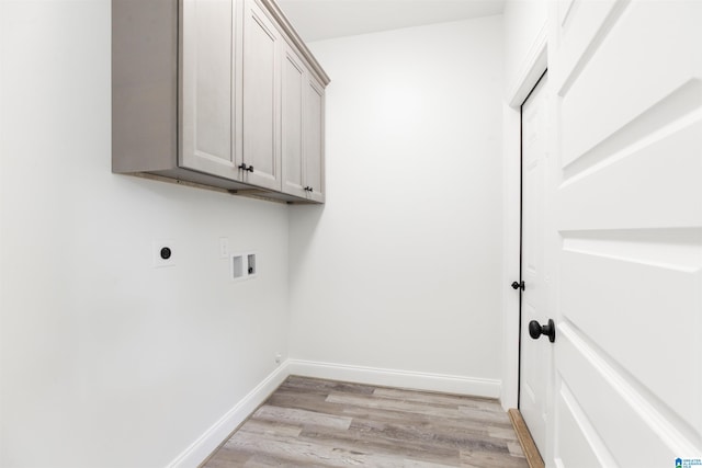 laundry room with washer hookup, light hardwood / wood-style floors, electric dryer hookup, and cabinets