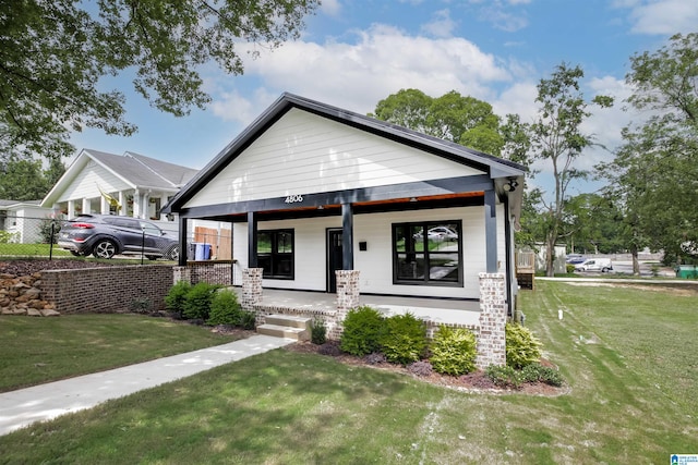 view of front of house with a porch and a front yard