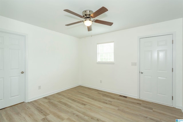 unfurnished room with light wood-type flooring and ceiling fan