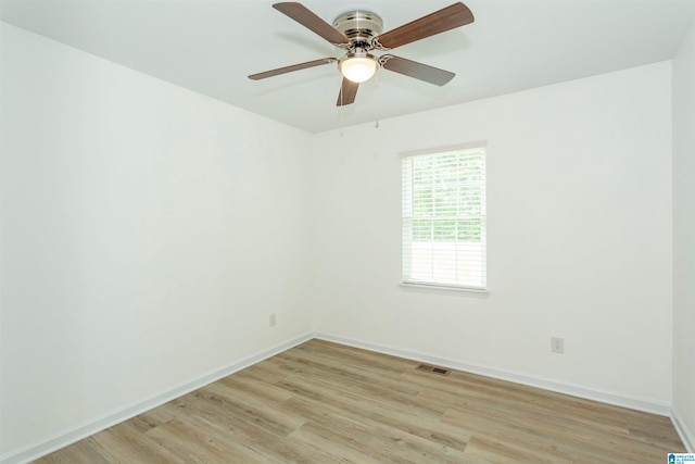 spare room with light hardwood / wood-style flooring and ceiling fan