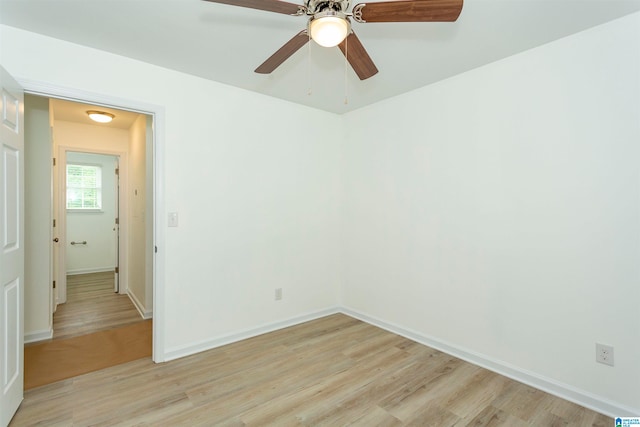 unfurnished room with light wood-type flooring and ceiling fan