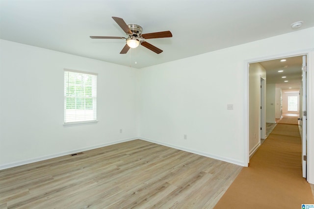 unfurnished room featuring light wood-type flooring and ceiling fan