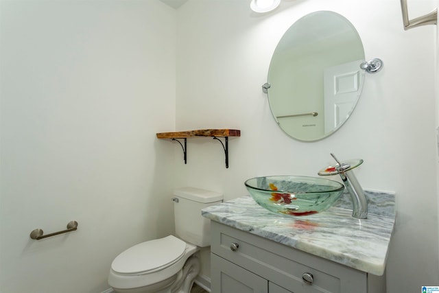 bathroom featuring toilet and vanity