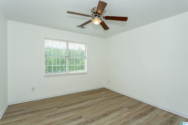 empty room with light wood-type flooring and ceiling fan