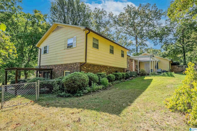 view of home's exterior featuring central air condition unit and a lawn