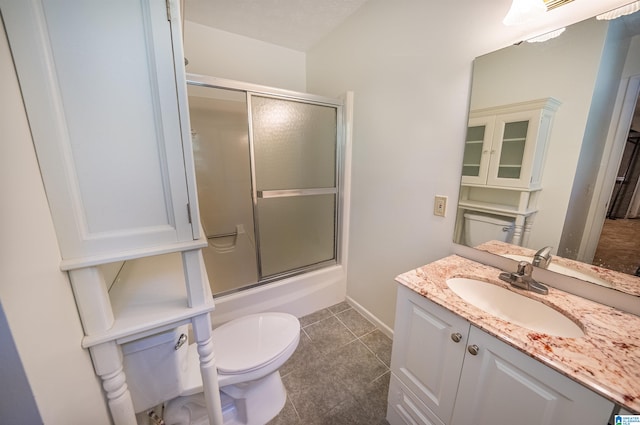 full bathroom with tile patterned flooring, toilet, bath / shower combo with glass door, and vanity