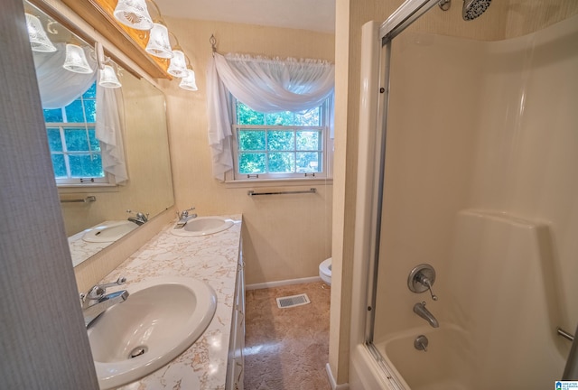 full bathroom featuring enclosed tub / shower combo, toilet, and vanity