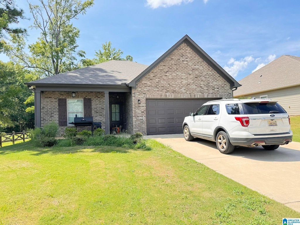 view of front facade featuring a garage and a front lawn