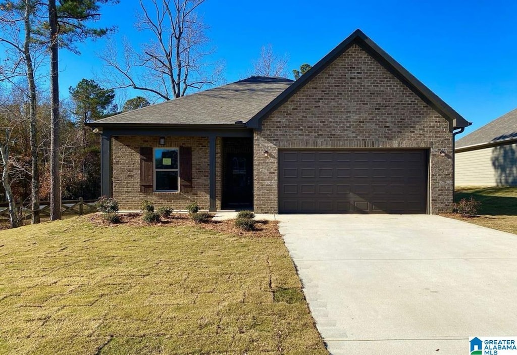 55 Ridgeview Cir, Jemison, AL 35085 - view of front facade with an attached garage, brick siding, and a front yard