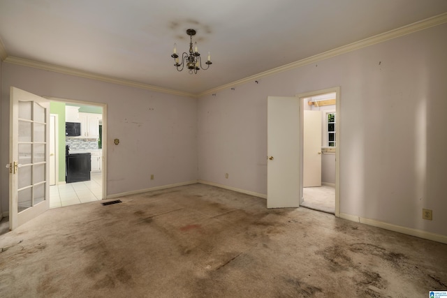 spare room featuring light tile patterned flooring, a chandelier, and ornamental molding