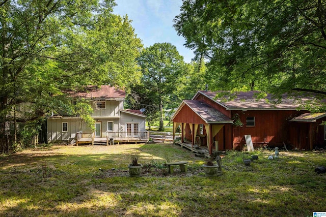 back of house with a yard and a wooden deck