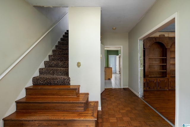 staircase featuring tile patterned flooring