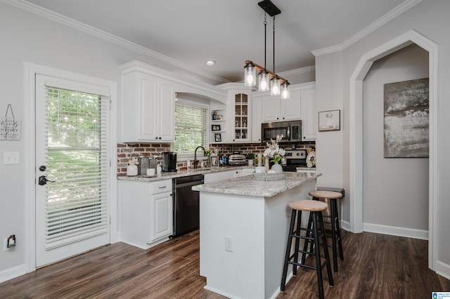 kitchen with white cabinetry, a center island, a healthy amount of sunlight, and dishwasher