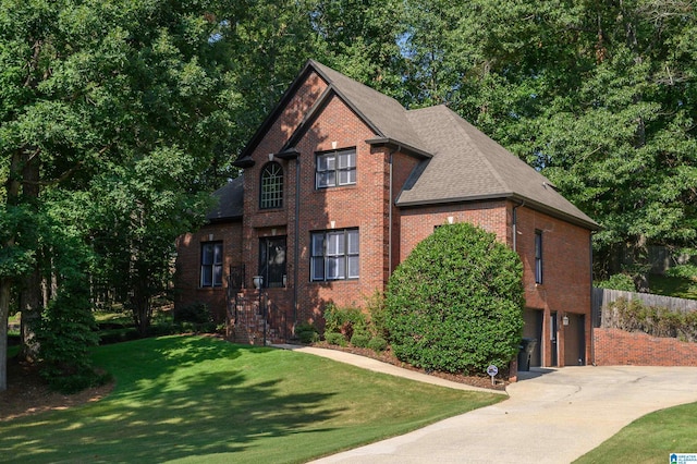 view of front facade with a garage and a front lawn