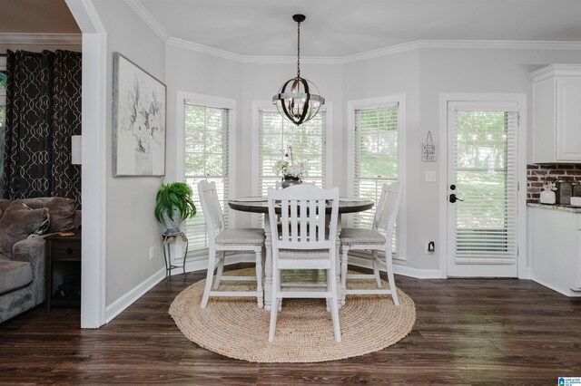 dining area with ornamental molding, dark hardwood / wood-style floors, and a chandelier