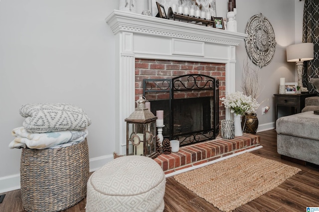 living room with dark hardwood / wood-style flooring and a fireplace