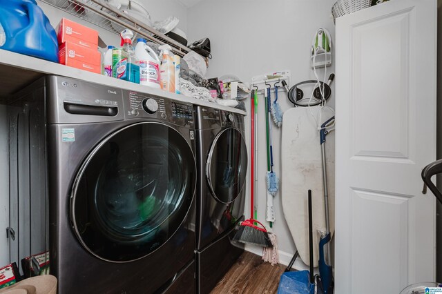 clothes washing area featuring washer and dryer and wood-type flooring