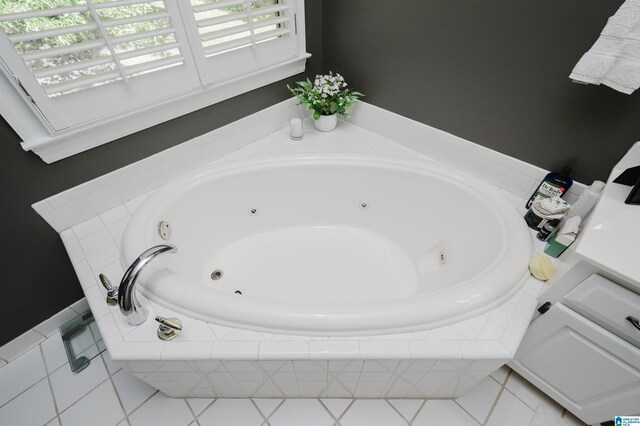 bathroom featuring tile patterned flooring and a relaxing tiled tub