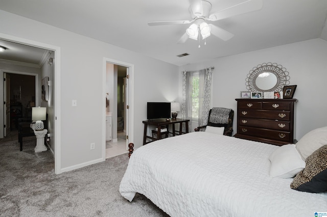 bedroom with crown molding, light carpet, ceiling fan, and connected bathroom