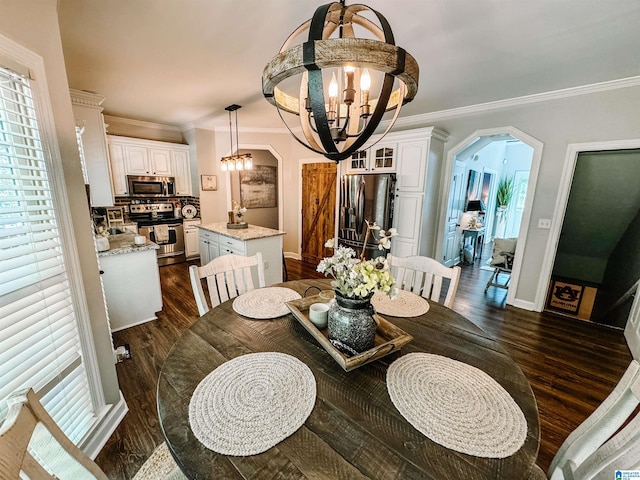 dining room featuring ornamental molding, dark hardwood / wood-style flooring, and a chandelier