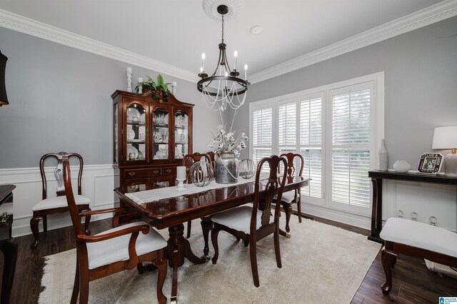 living room featuring crown molding, a chandelier, a brick fireplace, and wood-type flooring