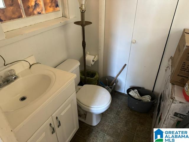 bathroom with tile patterned floors, toilet, and vanity