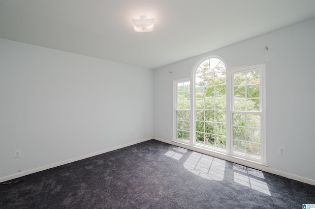 empty room featuring dark colored carpet