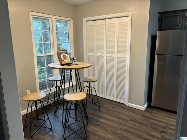 dining space featuring dark wood-type flooring