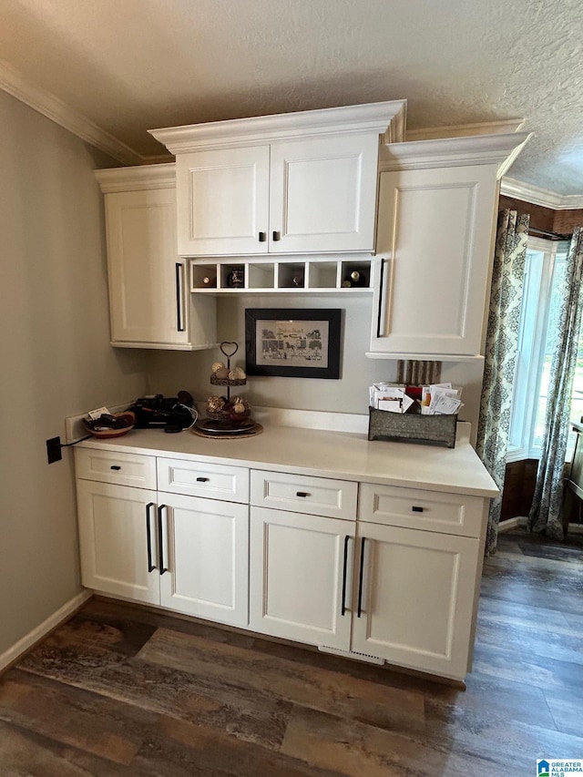 bar with baseboards, a textured ceiling, dark wood-type flooring, and crown molding