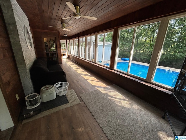 sunroom featuring wood ceiling and wood finished floors