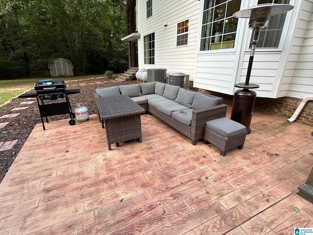 view of patio featuring an outdoor structure, outdoor lounge area, a storage shed, and area for grilling