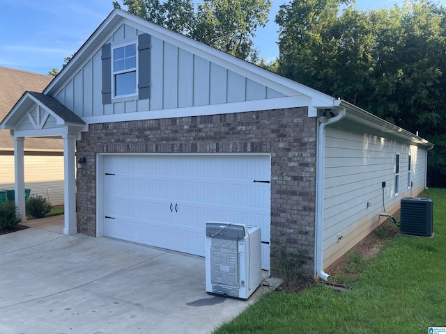 exterior space featuring a garage and central AC