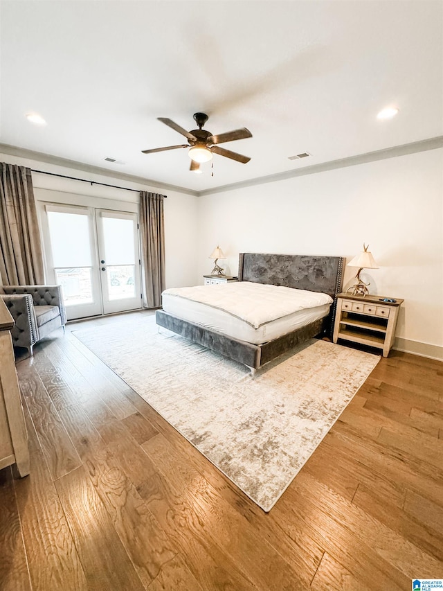 bedroom with ceiling fan, access to outside, french doors, and wood-type flooring