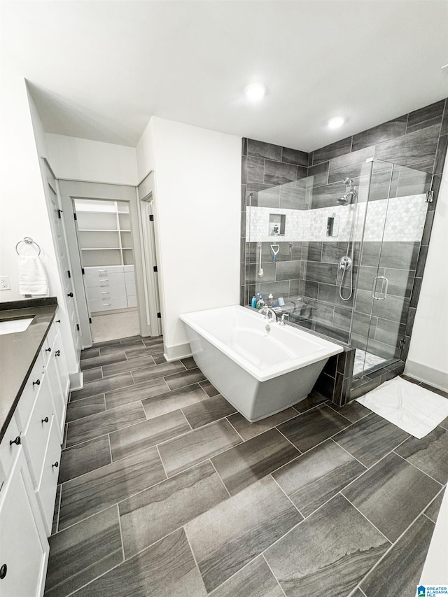 bathroom with vanity and independent shower and bath