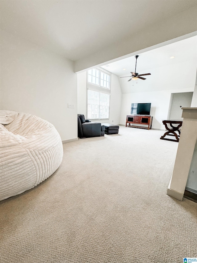 carpeted living room featuring vaulted ceiling and ceiling fan